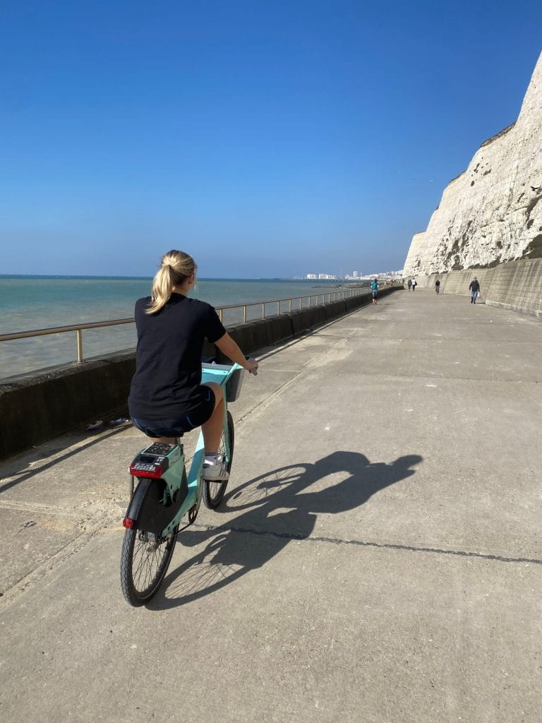 Riding a bike along brighton undercliff.