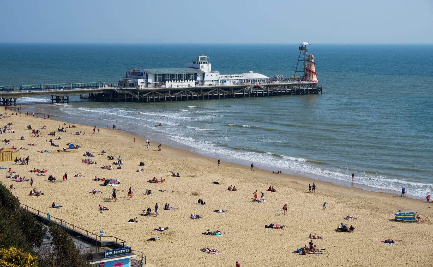 Bournemouth pier and beach on a sunny day.