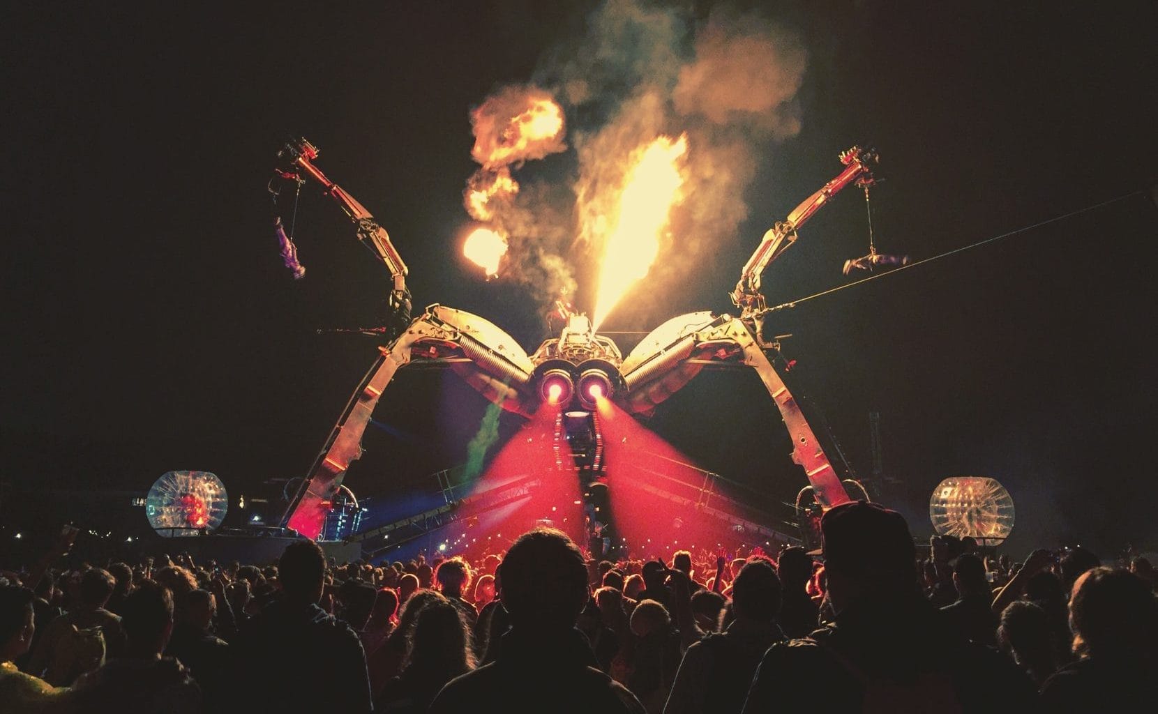 A stage shaped like a spider at glastonbury festival.