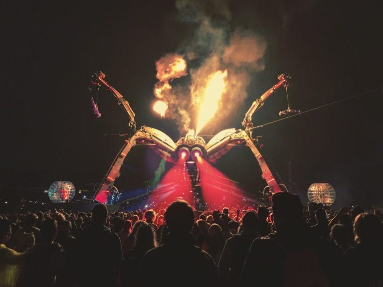 A stage shaped like a spider at glastonbury festival.