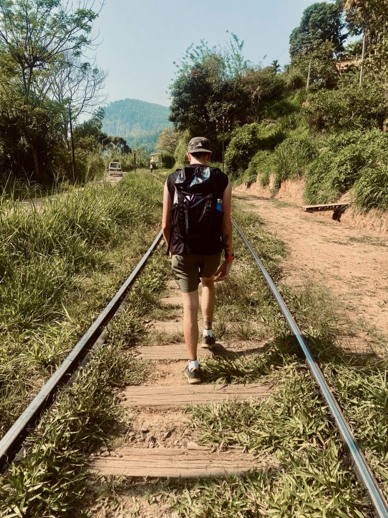 Man walks along train tracks to ella rock 2023.