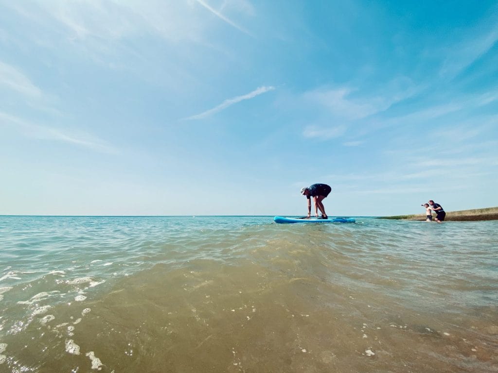 Man paddleboarding at brighton beach.