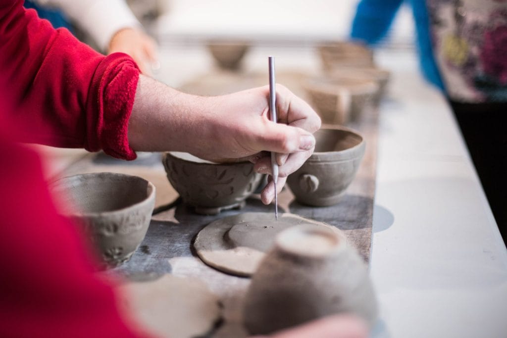 Painting pottery pieces.